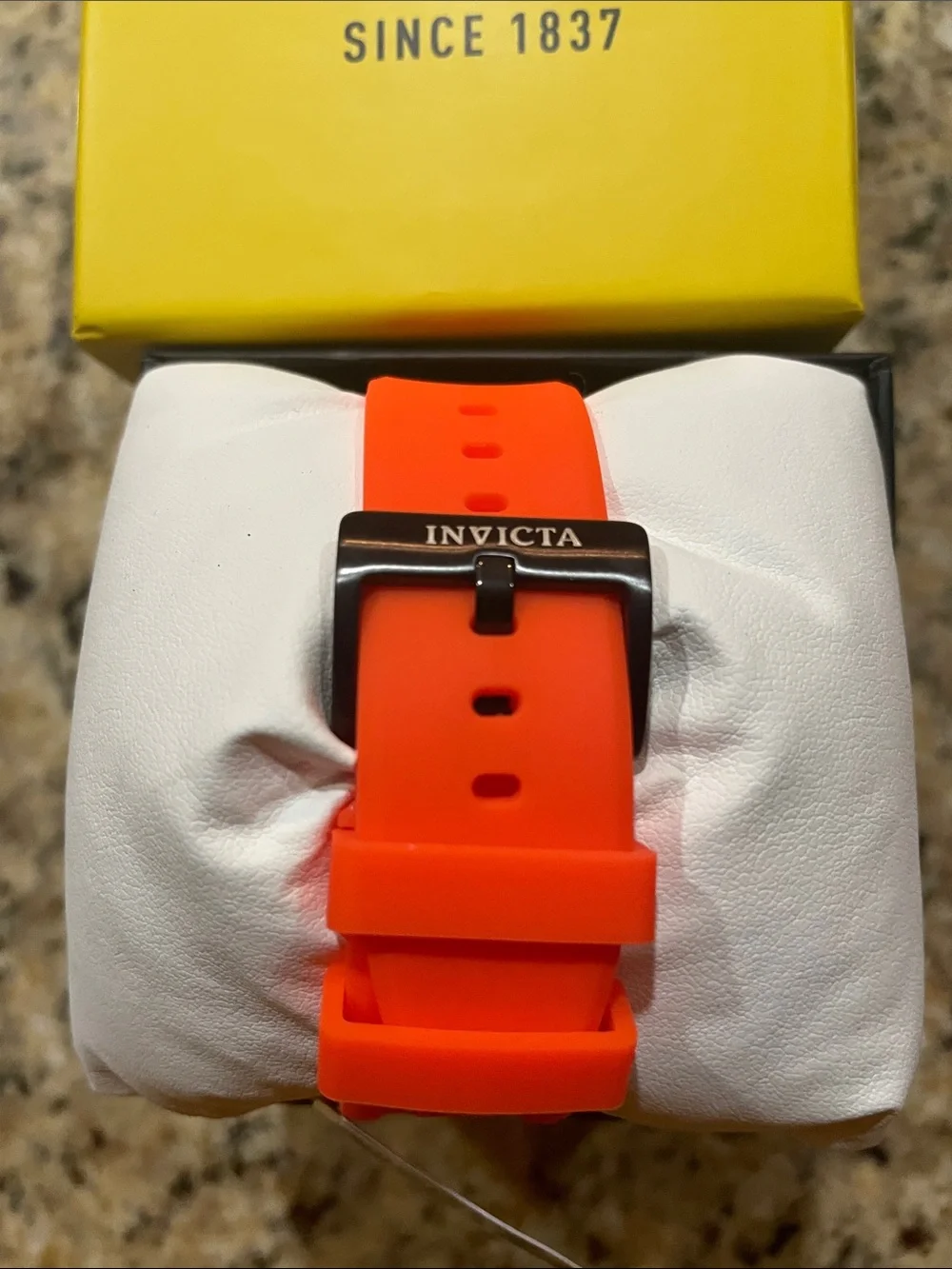 Invicta Black Rim Watch with Orange Strap and Gray Dial Accents